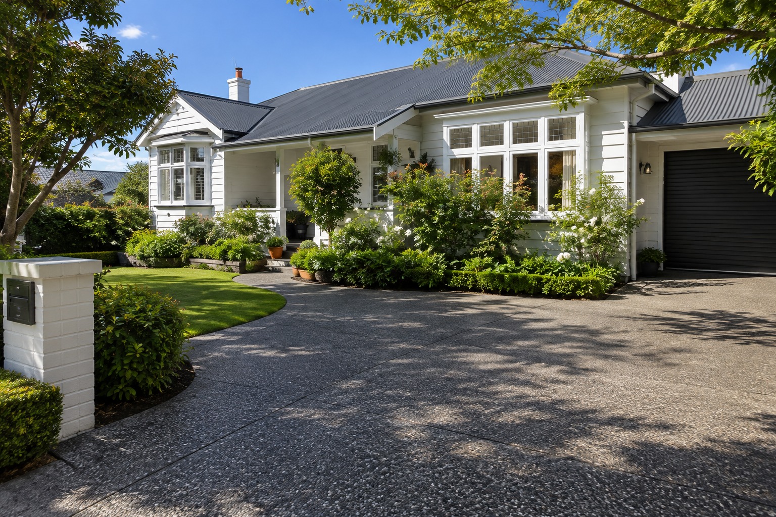 Exposed aggregate driveway in front of a white weatherboard home in Hobart